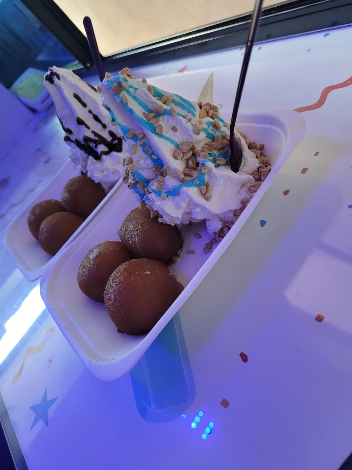 Loaded ice cream tub with gulab jamun and blue drizzle from Surrey Whippys